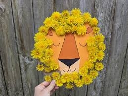 cardboard lion with dandelions as a mane