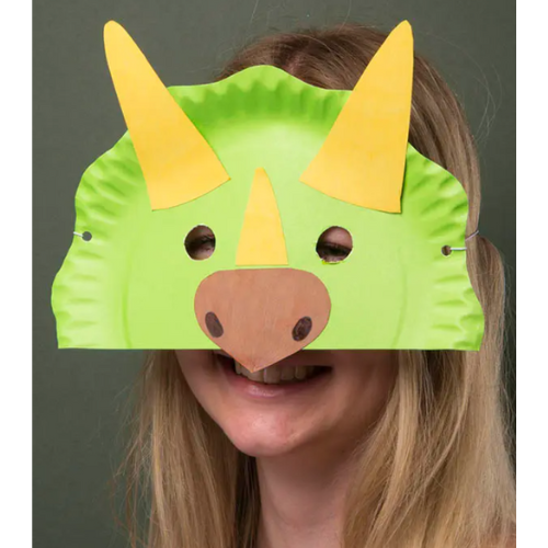 Girl with blonde hair wearing a green dinosaur mask with yellow horns.