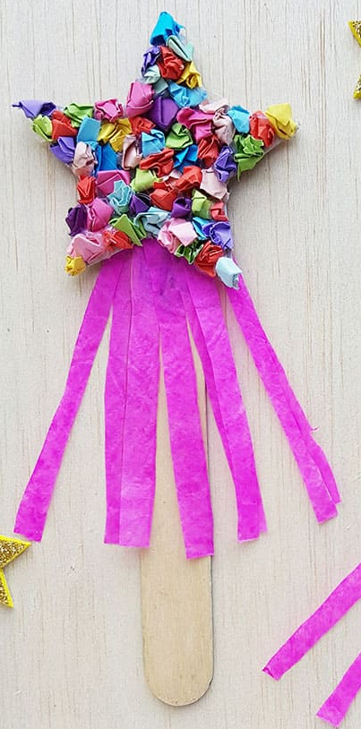 A wand made of a paper star, a popsicle stick, and crumpled tissue paper